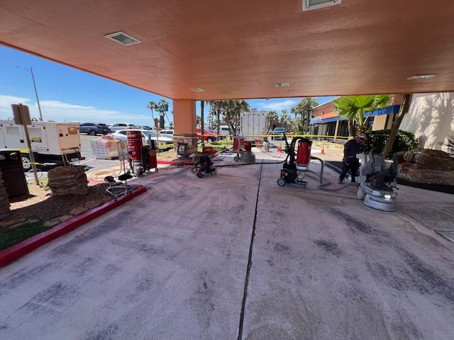 South Coast Epoxy crew grinding concrete at a Texas Gulf Coast commercial property